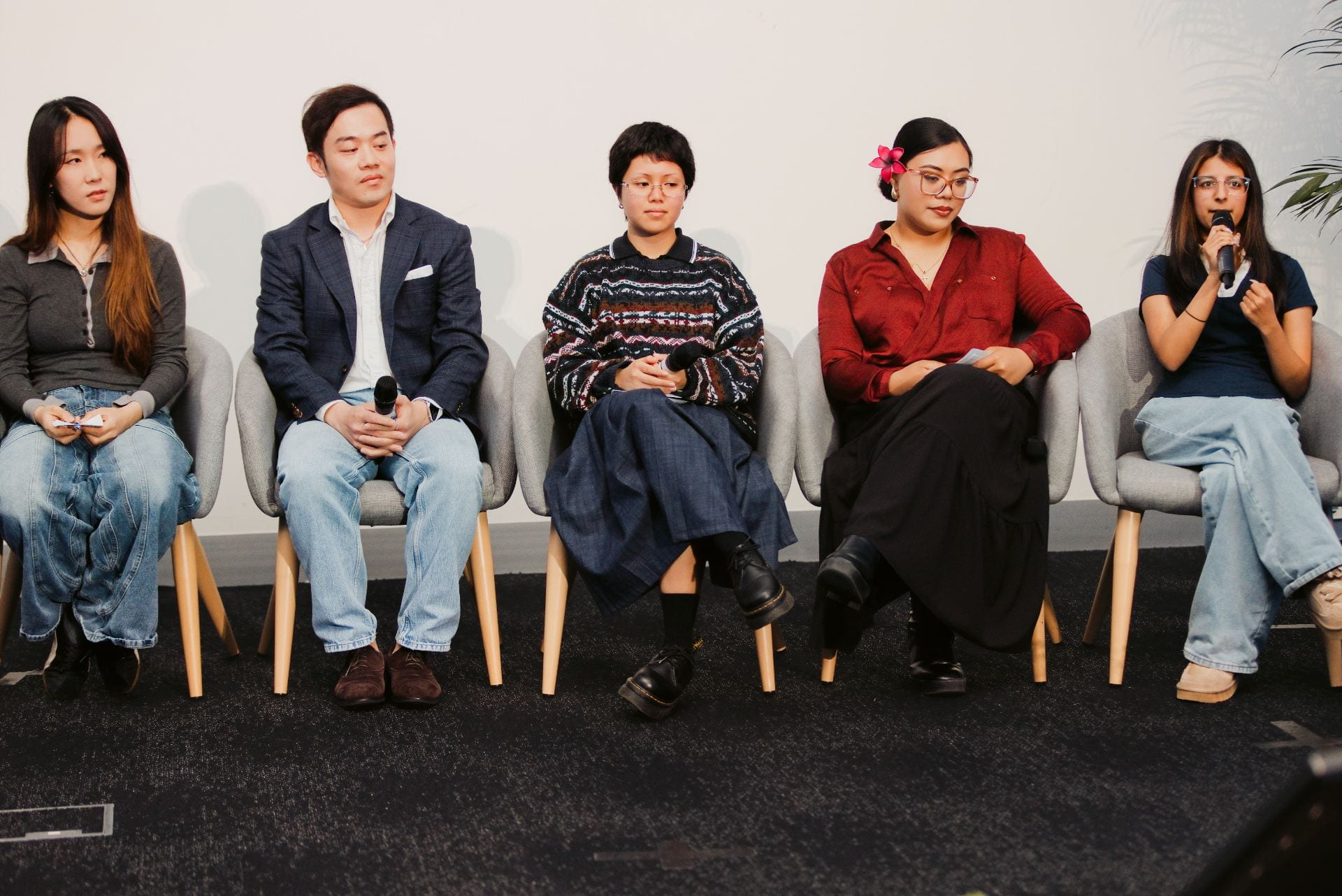 Five student panellists at ASPIRE 2026, with Savera speaking into a microphone